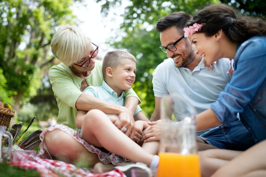 Happy family enjoying picnic in nature at summer